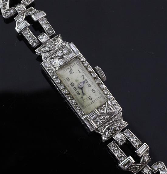 A ladys 1930s Art Deco platinum and diamond set cocktail watch, 6.75in.